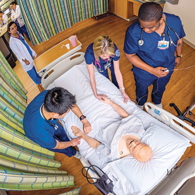 Picture of Hands-on training in the use of authentic health care equipment is part of the Smart Hospital experience for all students.